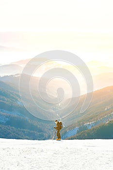 Lyžiar so slnkom za chrbtom sa pripravuje na zjazd do prekrásnej doliny Chopku - Slovensko