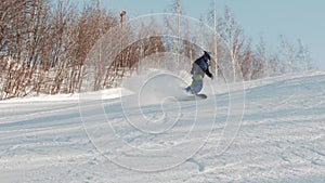 Skier technically carves down the hill and performs a tripod snowboarding trick