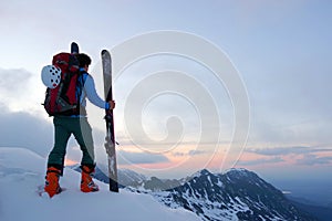 A skier watching the sunset.