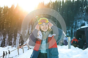 Skier young woman with ski mask outdoor in sunny day