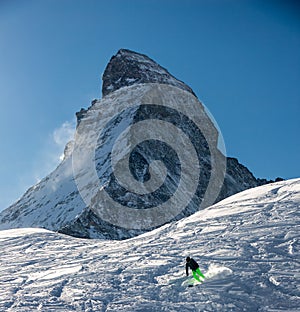 Skier in Zermatt in front of the Matterhorn view mountain winter snow landscape sunset backlight