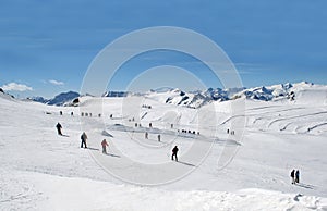 Skiers on Alpine ski slope photo