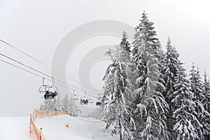 The skiers are on a cableway in Bukovel ski resort