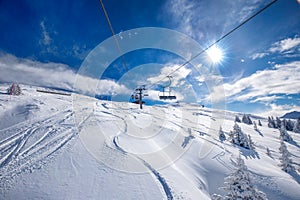 Skiers on the chair lift in Tyrolian Alps, Kitzbuehel, Austria