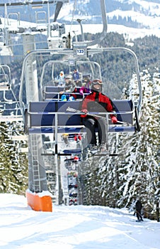 Skiers in chairlift photo