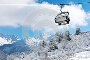 skiers in chairlift above beautiful snowy winter landscape in Alps