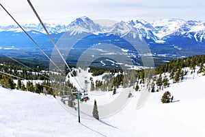 Skiers on Chairlift Up a Ski Slope in the Canadian Rockies