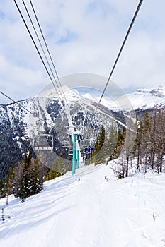 Skiers on Chairlift Up a Ski Slope in the Canadian Rockies