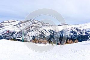 Skiers on Chairlift Up a Ski Slope in the Canadian Rockies