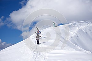 Skiers climbing a snowy mountain