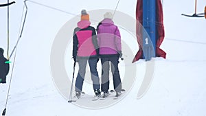 Skiers are climbing up the mountain on a drag lift