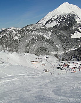 Skiers descend to tiny mountain village