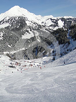 Skiers descend to tiny mountain village