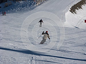 Skiers descending a ski piste