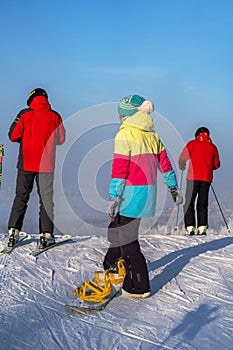 Skiers are down the hill, winter day, Moscow region, Russia