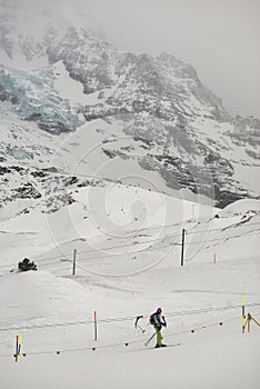 Skiers with Eiger north face behind, In winter. Kleine Scheidegg, Bernese Oberland, Switzerland