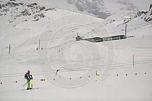 Skiers with Eiger north face behind, In winter. Kleine Scheidegg, Bernese Oberland, Switzerland