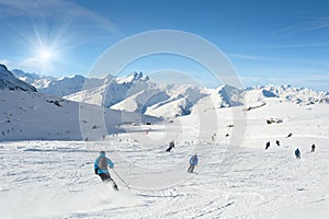 Skiers enjoy in the mountain on a sunny day