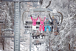 Skiers family together in ski chair