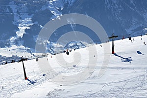 Skiers going up with a ski lift in the Alps