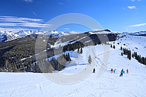 Skiers high in the Rocky Mountains of Vail, Colorado in winter