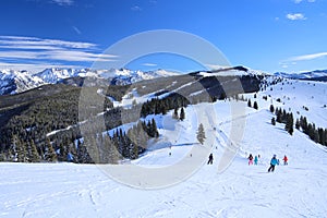 Skiers high in the Rocky Mountains of Vail, Colorado in winter photo