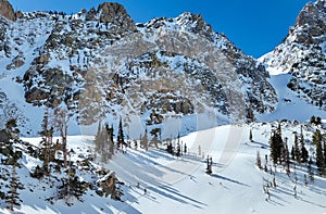 Skiers hiking up to a mountain ridge