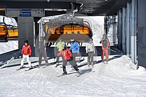 Skiers leaving chairlift