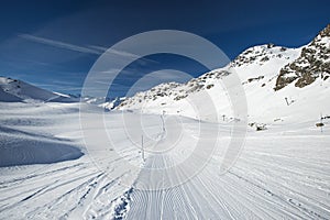 Skiers on a piste in alpine ski resort