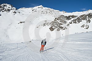 Skiers on a piste in alpine ski resort