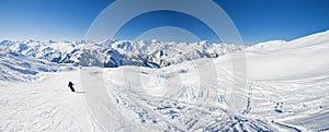 Skiers on a piste in alpine ski resort