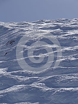 Skiers on piste in high Alpine ski area