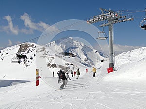 Skiers on piste on sunny day