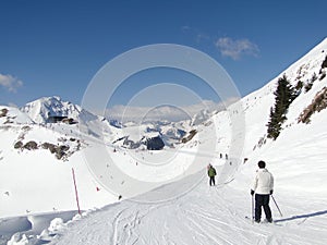 Skiers on piste on sunny day