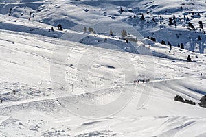 Skiers on a piste in the Swiss Alps