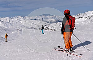 Skiers riding down the slope at the Val Thorens Ski resort in France.