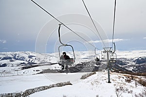 Skiers riding the lift chair during the skiing season in Armenia, Tsaghkadzor