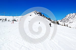 Skiers riding on a slope in Strbske Pleso ski resort