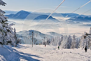 Skiers on ski lift on ski resort on Kubinska Hola during winter