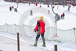 Skiers skiing climb a yoke on a mountain. Light skiing track in Bakuriani