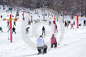 Skiers skiing climb a yoke on a mountain. Light skiing track in Bakuriani