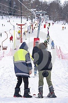 Skiers skiing climb a yoke on a mountain. Light skiing track in Bakuriani