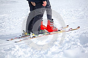 Skiers skiing climb a yoke on a mountain. Light skiing track in Bakuriani