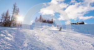 Skiers skiing downhill on mountain sunny landscape