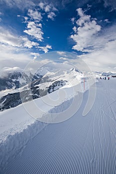 Skiers skiing in Kitzbuehel ski resort and enjoying Alps view fr photo