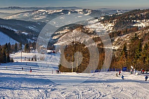 Skiers on slope of Velka Raca - Oscadnica ski resort