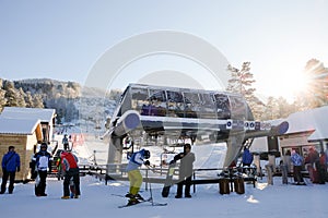 Skiers and snouborders on snow slope in winter ski resort. Ski elevator on snow mountain. Winter activity concept. Cable car ski