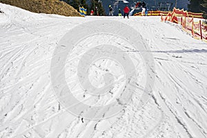 skiers on a snow slope for beginners on a sunny day.