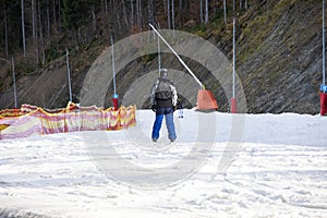 skiers on a snow slope for beginners on a sunny day.