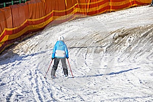 skiers on a snow slope for beginners on a sunny day.